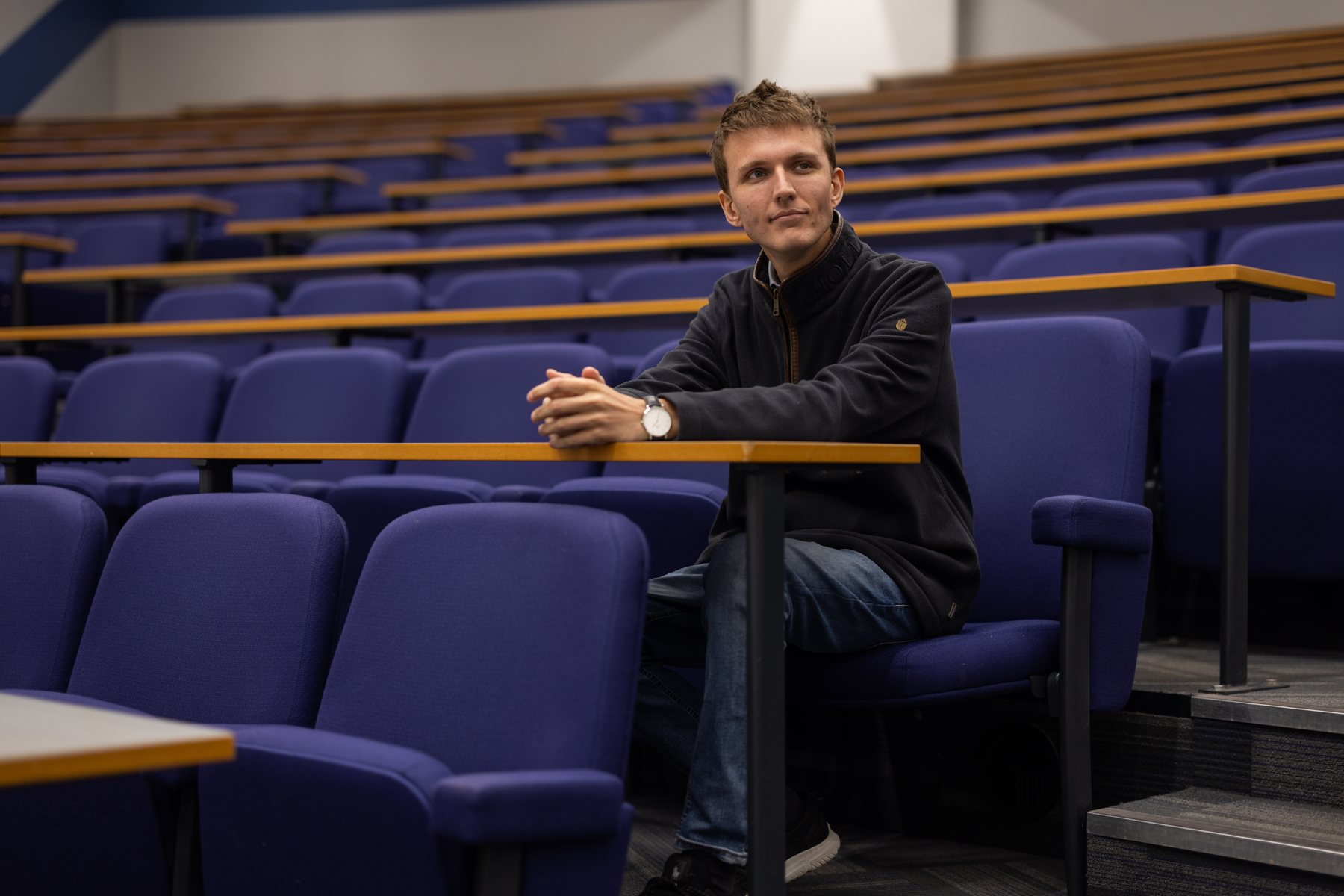 Sebastian Moore seated in a lecture theatre
